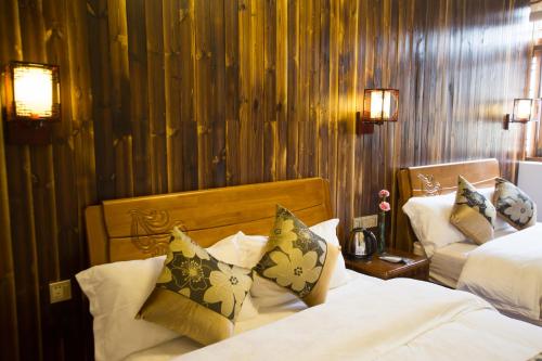 a hotel room with two beds with pillows at Chaozhou Hello Inn in Chaozhou