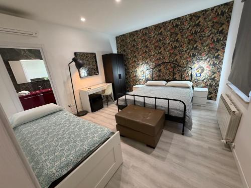 a bedroom with two beds and a wall mural at VILLA NATURA in Corropoli