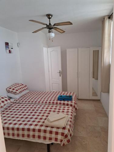a bedroom with a bed and a ceiling fan at B10 Las Arenas in Caleta De Fuste