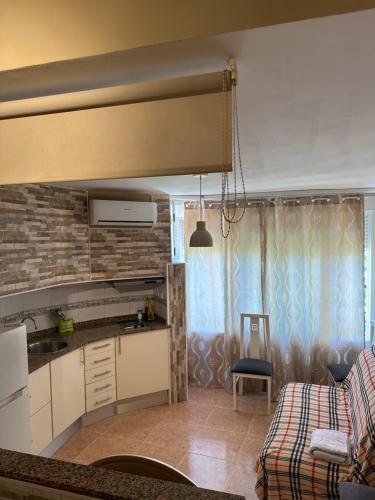 a kitchen and a living room with a couch at Promar Playa 255 in La Pineda