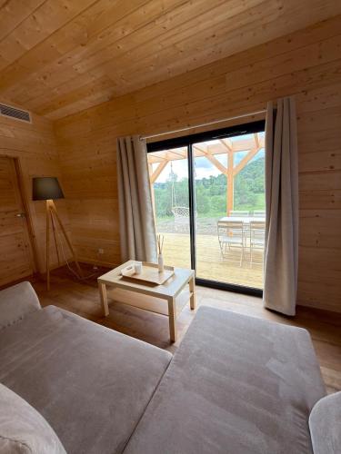 a bedroom with a bed and a table and a window at Chalet de Saint Martin in Roquefort-des-Corbières
