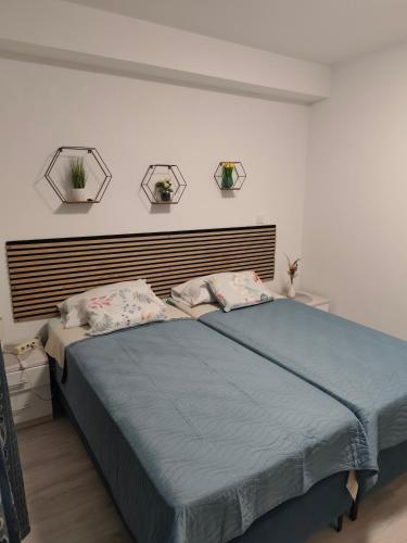 a bedroom with a large bed with two pillows at Guest House Oscar near the Sea and river in Mokošica