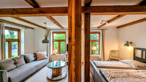 a living room with a couch and a table at Ferienwohnung Lütt Quickborn in Quickborn