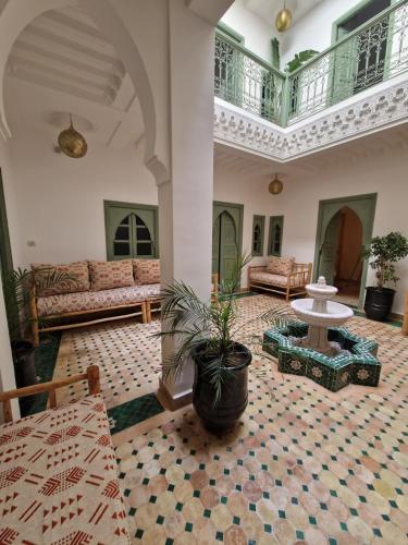 a large living room with a couch and a table at Riad Dar Yamna Marrakech in Marrakesh