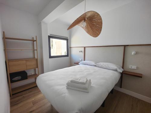 a bedroom with a white bed with two towels on it at Nido Anaga in Santa Cruz de Tenerife
