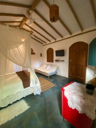 a bedroom with a bed at Chalé Rosa in Trancoso