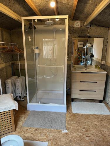 a bathroom with a shower and a sink at Les Jardins Vert Framboise yourte et chambres d'hôtes in Beaufour