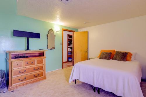 a bedroom with a bed and a tv and a dresser at Golf, Lakes & Trails! Truth Or Consequences Home in Truth or Consequences