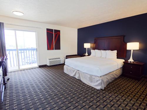 a hotel room with a bed and a large window at SilverStone Inn North Spokane in Spokane