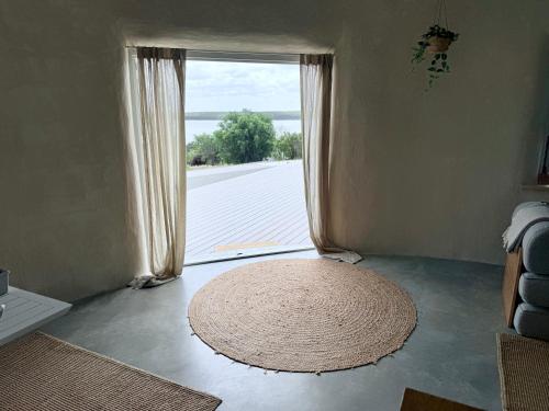 a room with a rug in front of a window at Whales and Bales in Bremer Bay
