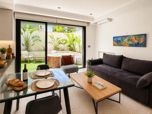 a living room with a couch and a table at Prestige House La Marsa Terrasse Jacuzzi & Garage in La Marsa