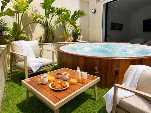 a hot tub with a tray of food on a table at Prestige House La Marsa Terrasse Jacuzzi & Garage in La Marsa