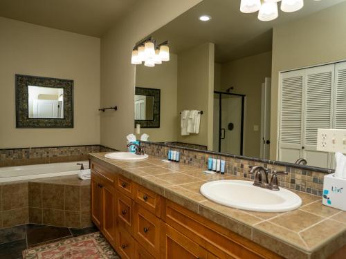 a bathroom with two sinks and a large mirror at Running Y Resort in Klamath Falls