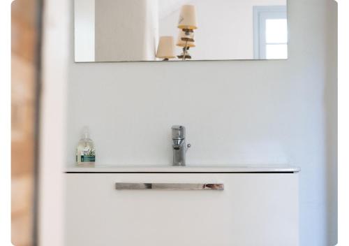 a bathroom door with a sink and a mirror at Maison de Charme,Plage et Forêt, 6 personnes in Seignosse
