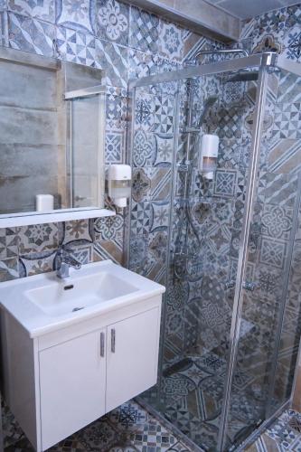 a bathroom with a sink and a shower at Hayal Ada in Bozcaada