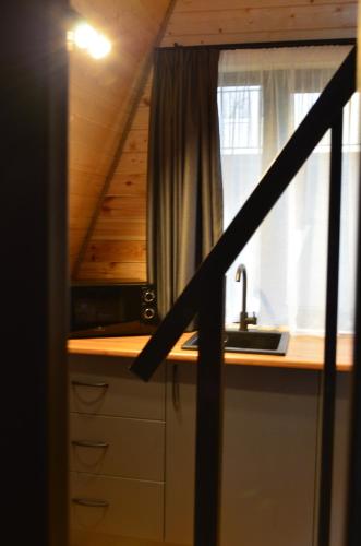 a kitchen with a sink and a window at MM's Cottage in Kazbegi