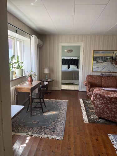 a living room with a couch and a table at Starby bondgård in Ängelholm