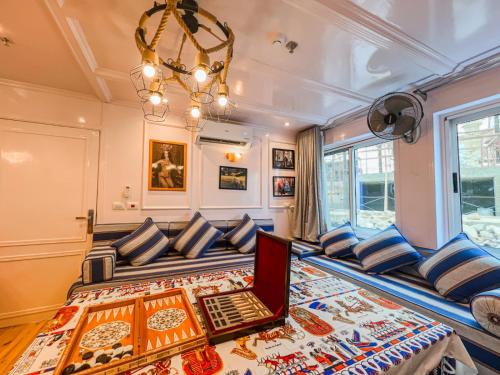 a room with a couch with a laptop on it at Youssef Nile Boat in Luxor