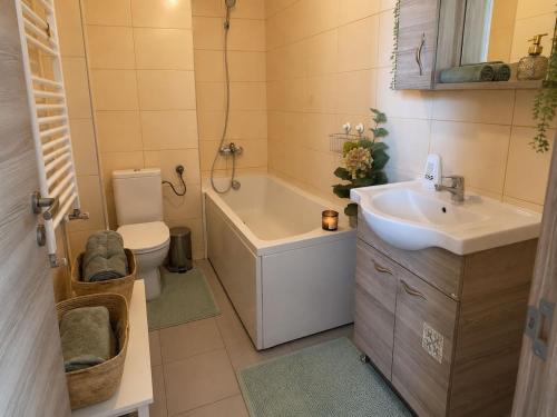 a bathroom with a tub and a sink and a toilet at Dream Catchers LOFT in Bucharest