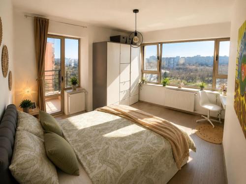 a bedroom with a large bed and a large window at Dream Catchers LOFT in Bucharest