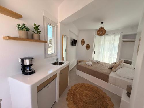 a small bedroom with a bed and a sink at K&M studio in Naxos Chora