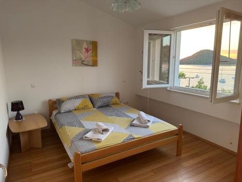 a bedroom with a bed with towels on it at Beachside 2-Bed Bliss! in Blace