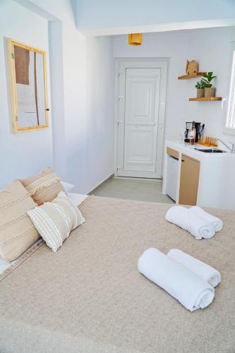 a living room with two white pillows on the floor at K&M studio in Naxos Chora