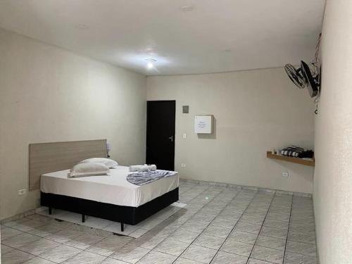 a bedroom with a bed in a room at Hotel São Mateus in São Paulo
