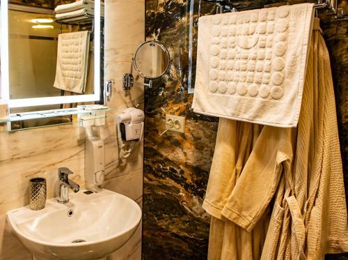 a bathroom with a sink and a mirror at Готель-Ресторан Соната in Sambir