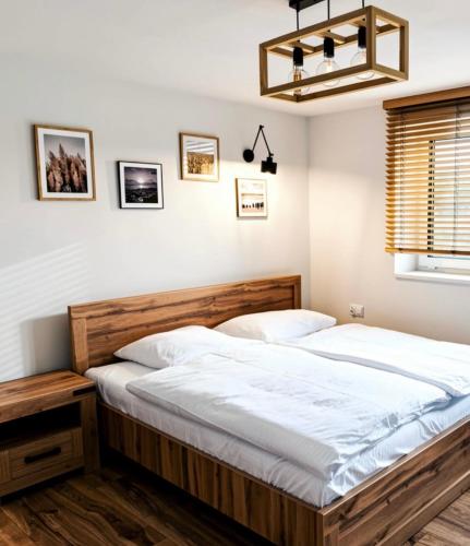 a bedroom with a large bed with white sheets at Siedlisko in Tuchów