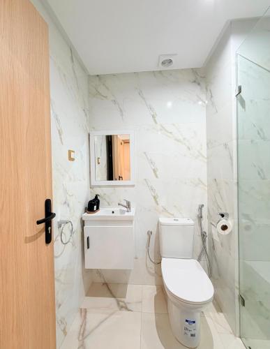 a bathroom with a toilet and a sink and a shower at Stay with US in Agadir