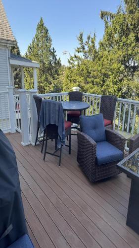 a wooden deck with chairs and a table and a table at Maggie S Place in Salem