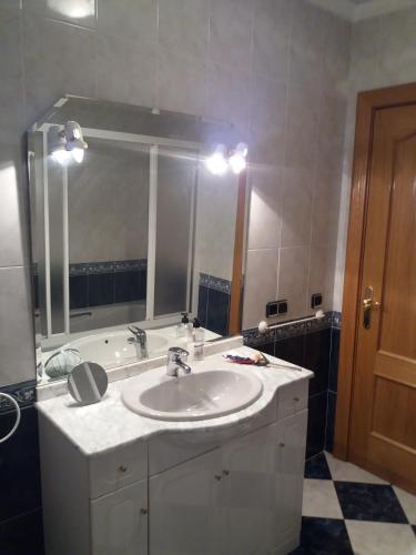 a bathroom with a sink and a mirror and a tub at Casa Rural Amelia in Cepeda