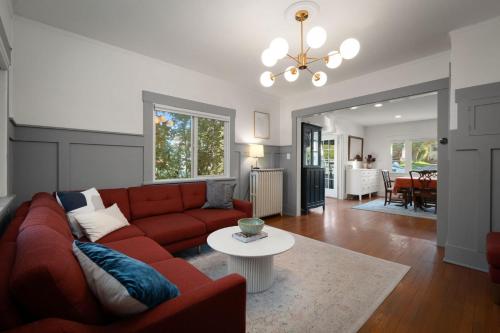 a living room with a red couch and a table at Yellow York House in Bellingham