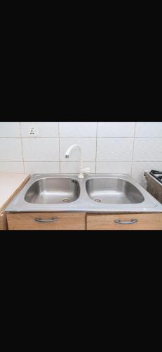 a kitchen sink with a faucet on top of it at Apartment 3 Brufut Residencies in Brufut