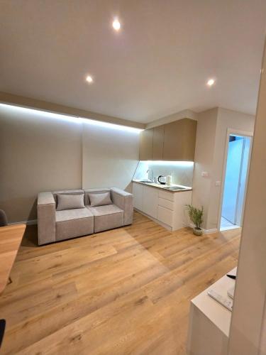 a living room with a couch and wooden floors at JACUZZI LIVING TIRANA center 1 in Tirana