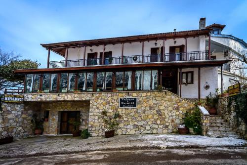 a building with a balcony on top of it at Guesthouse Mavrodimos in Eptalofos