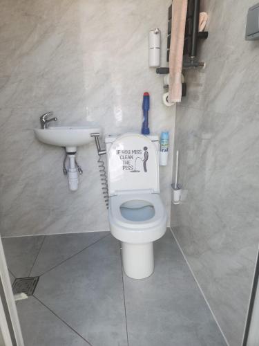 a bathroom with a toilet and a sink at Hideaway Retreat 1 & 2 in Belvedere