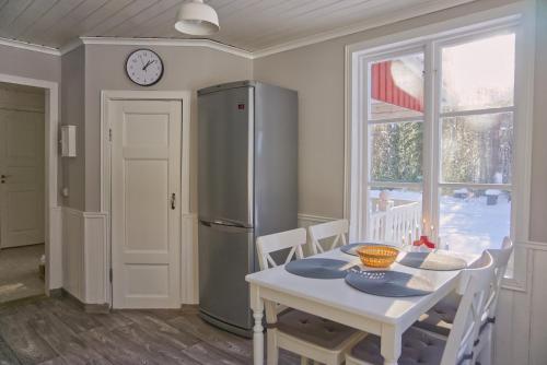 a kitchen with a table and a refrigerator at Cozy forest cabin in Vik