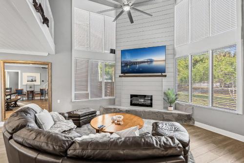 a living room with a leather couch and a table at 1055 Shady Lane in Merritt Island
