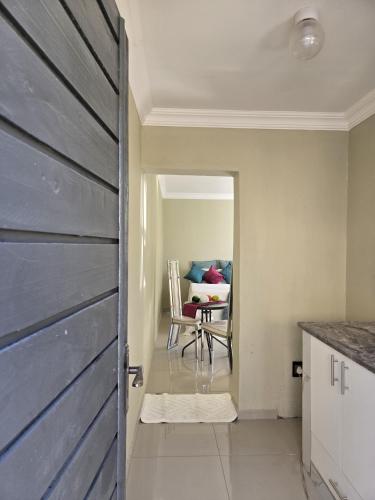 a door leading into a kitchen with a dining room at Aquasaints Sandton Logde in Johannesburg
