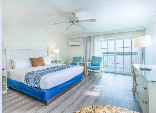 a hotel room with a bed and a balcony at Tween Waters Island Resort & Spa in Captiva