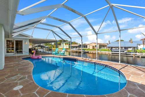 a large swimming pool with a retractable roof at 1480 W Riviera Dr in Merritt Island
