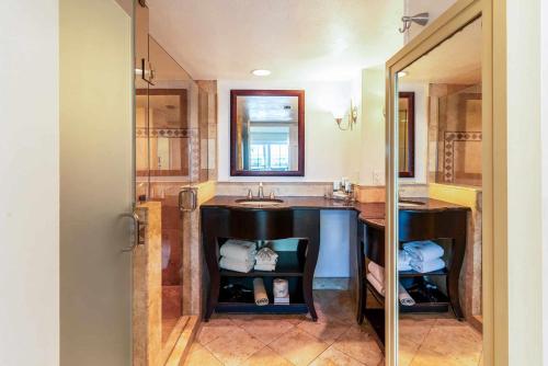 a bathroom with a sink and a mirror at Tween Waters Island Resort & Spa in Captiva