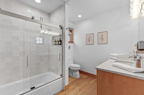 a white bathroom with a shower and a toilet at Stella del Mare in Dover ID in Dover