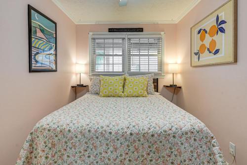 a bedroom with a bed with yellow pillows and a window at Steps to Beach! North Myrtle Beach (Cherry Grove) in Myrtle Beach