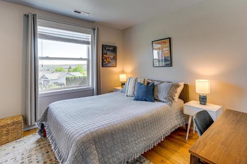 a bedroom with a bed and a large window at Hot Tub & Seasonal Pool: Remarkable Yakima Getaway in Yakima