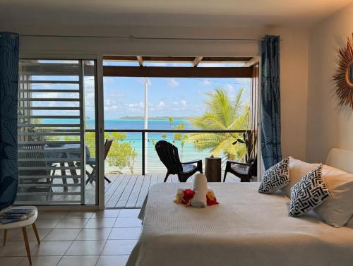 a bedroom with a bed with a view of the ocean at Breathtaking Bora Bora Lagoon View Studio in Bora Bora