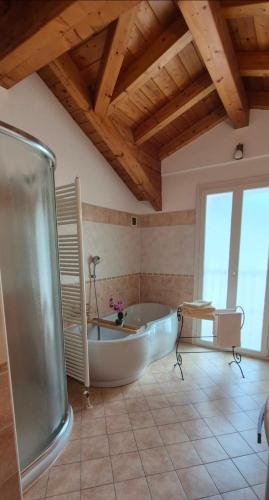 a large bathroom with a tub and a table at Casa Cuor Di Leone in Cannobio