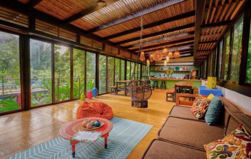 a living room with a couch and a table at La Shamana - Ecological Concept in Jungle in Cahuita